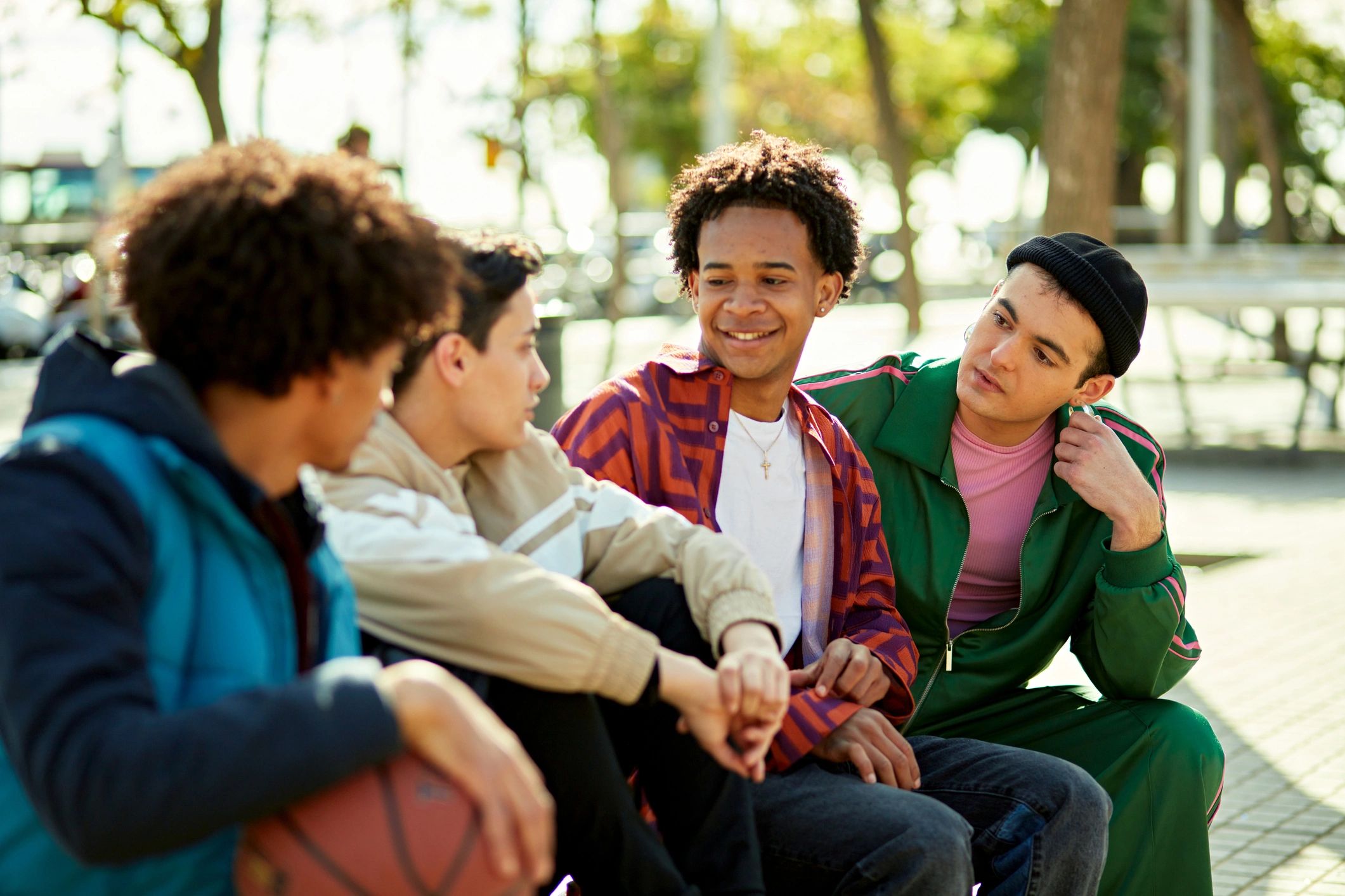Youth sitting together outdoors in conversation and community