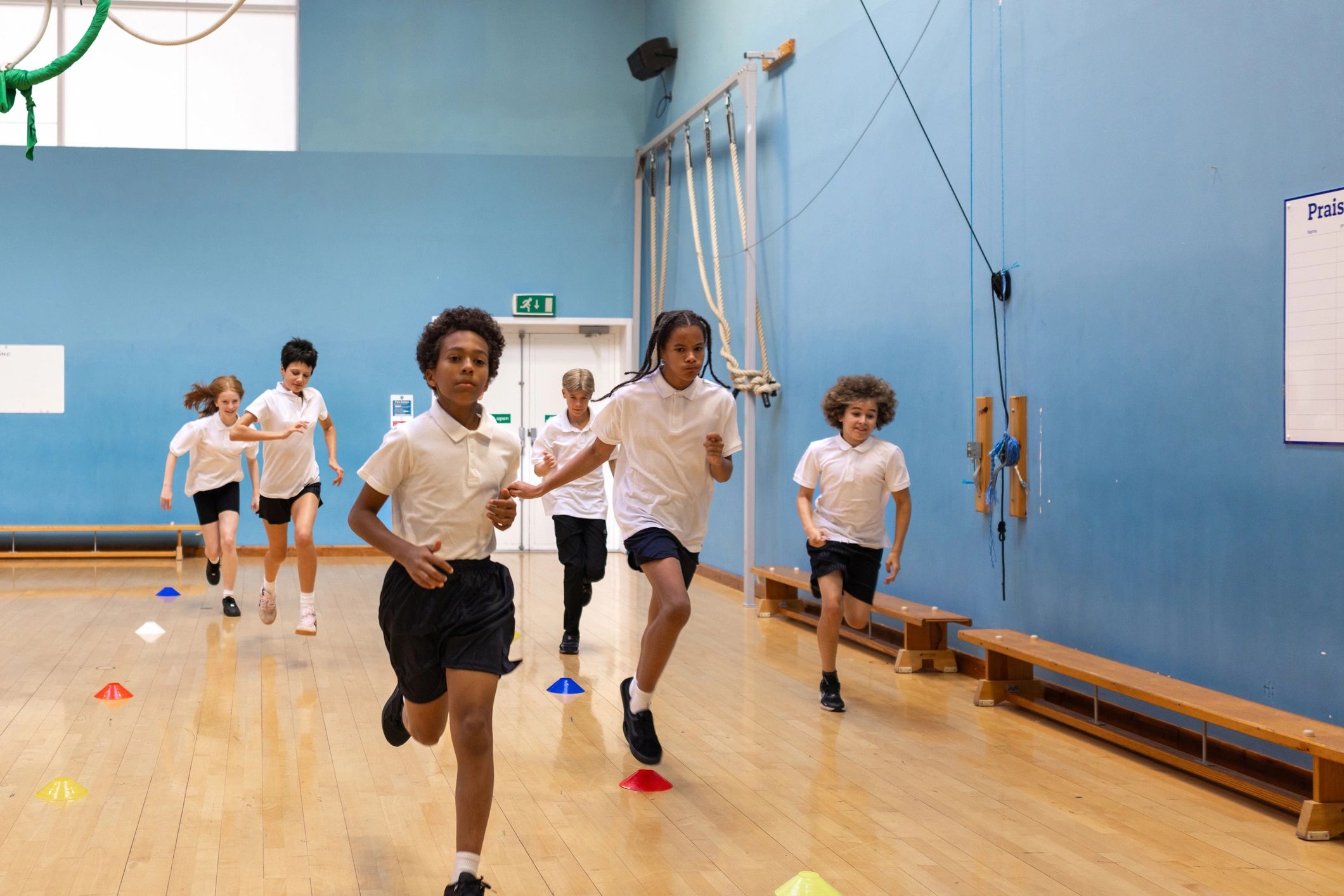 Teenagers participating in a group sports activity indoors