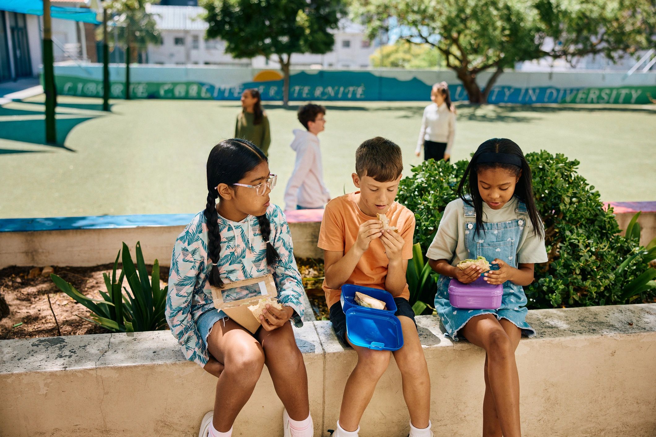 Children sharing time together outdoors near a recreation area
