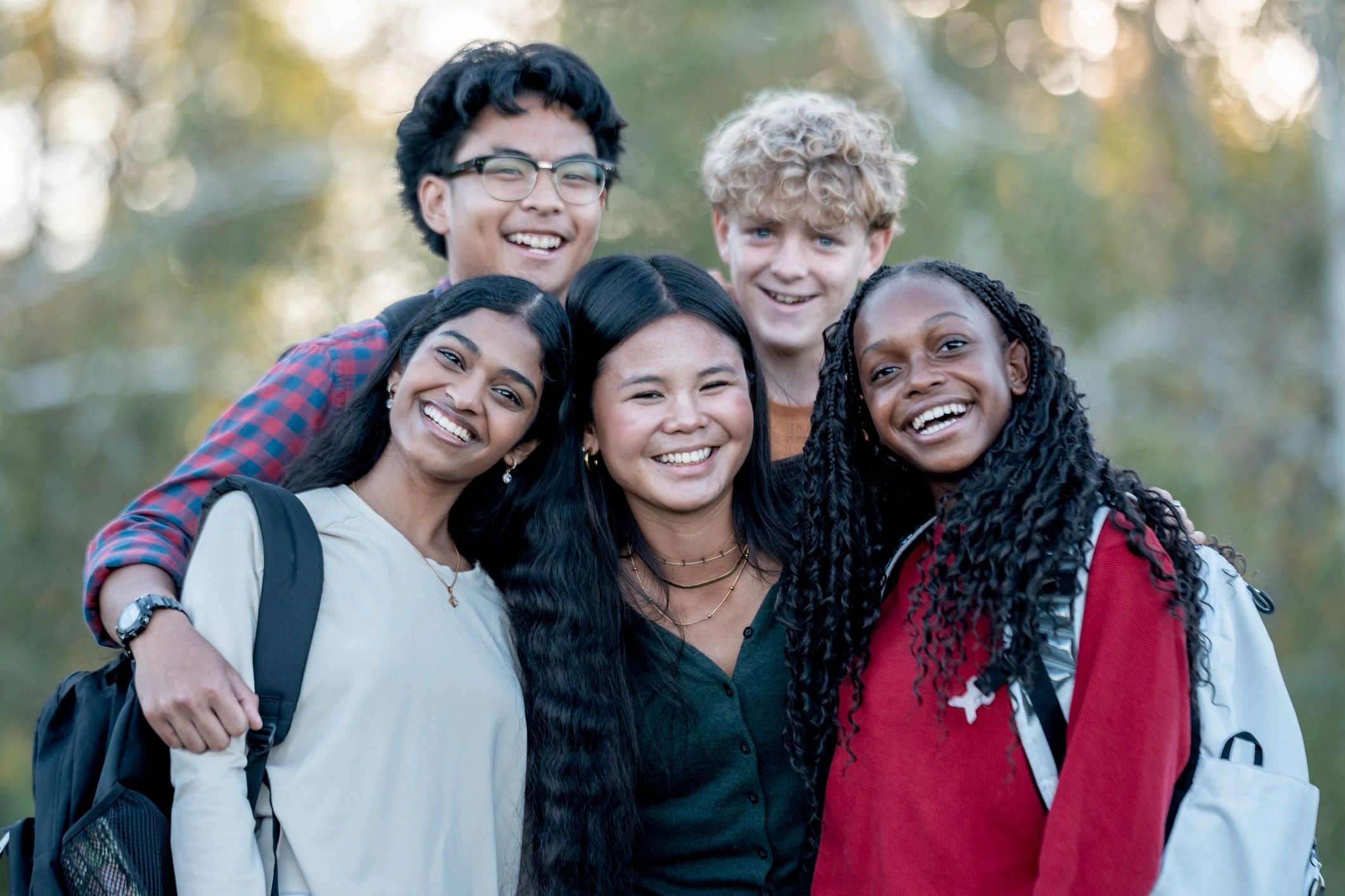 Diverse young people smiling together outdoors during a cultural exchange experience